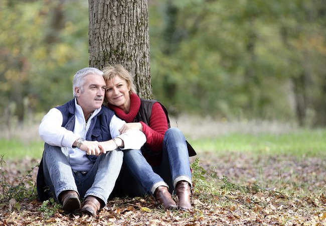 Couple sat by tree